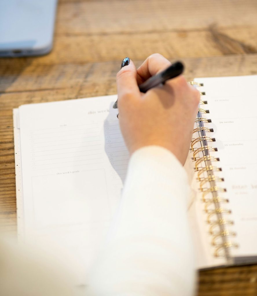 A woman takes notes in a book.